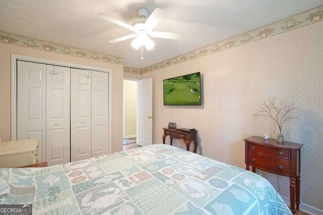 bedroom with ceiling fan and a closet