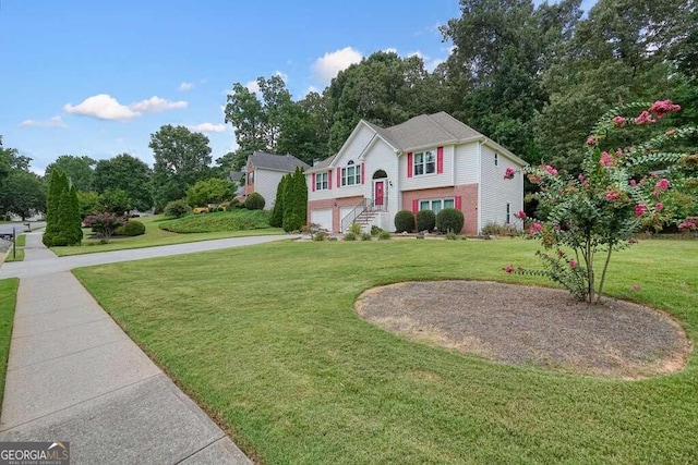 bi-level home with a front yard and a garage