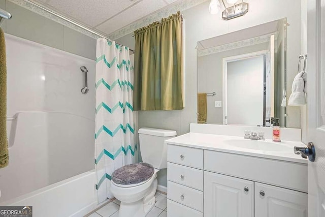 full bathroom with shower / bath combo with shower curtain, tile patterned flooring, vanity, and toilet