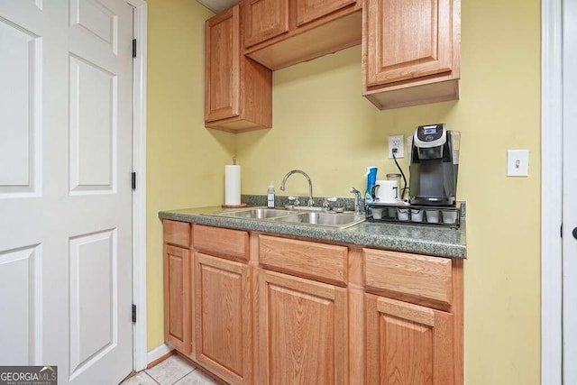 kitchen featuring light tile patterned floors and sink