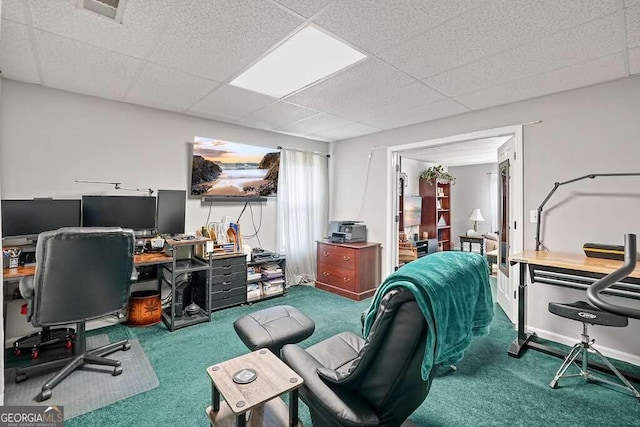 carpeted office space featuring a paneled ceiling