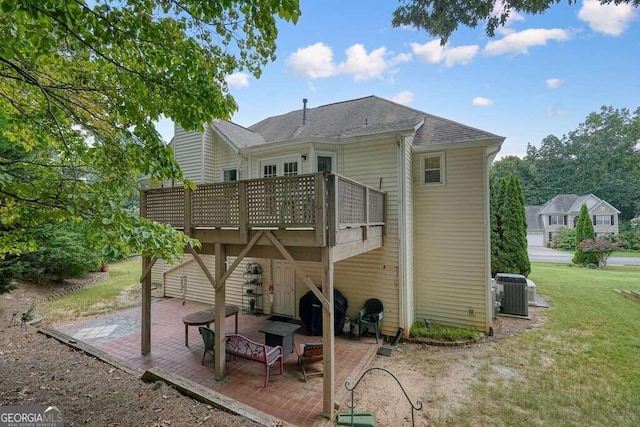 rear view of house featuring a lawn, cooling unit, a patio area, and a deck