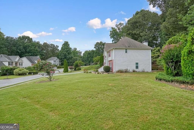 view of property exterior with a yard