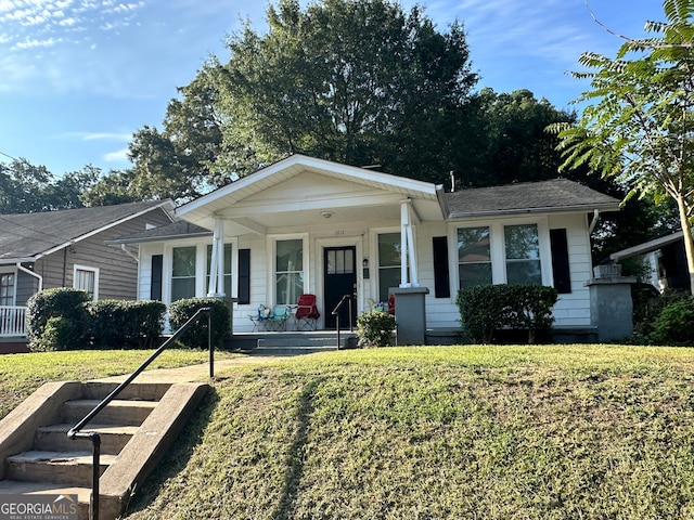 view of front of house with a front yard and a porch