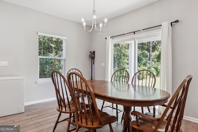 dining area with an inviting chandelier and light wood-type flooring