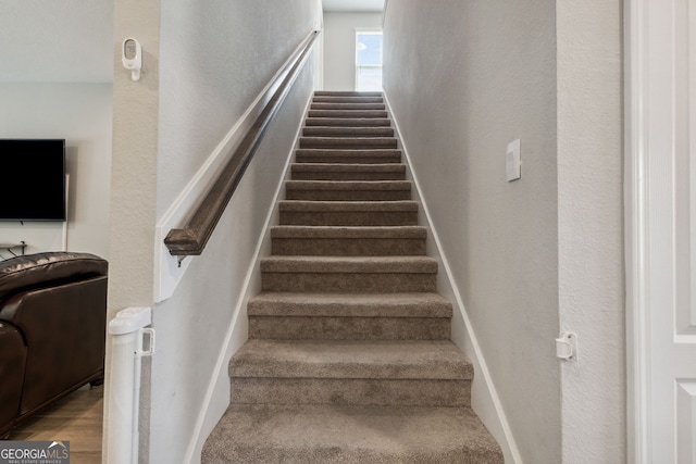 stairs featuring hardwood / wood-style flooring