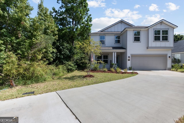 view of front of property with a garage and a front lawn