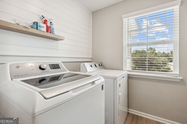 washroom with dark hardwood / wood-style floors and washer and clothes dryer