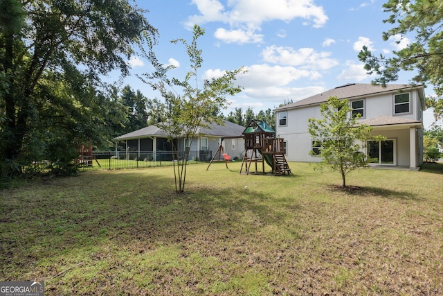 view of yard with a playground and a sunroom