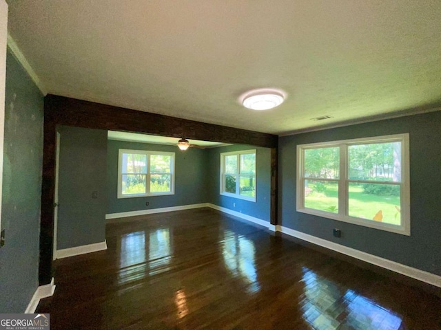 empty room featuring dark hardwood / wood-style flooring and a textured ceiling