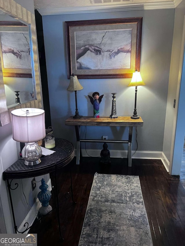 interior space with dark hardwood / wood-style flooring and crown molding