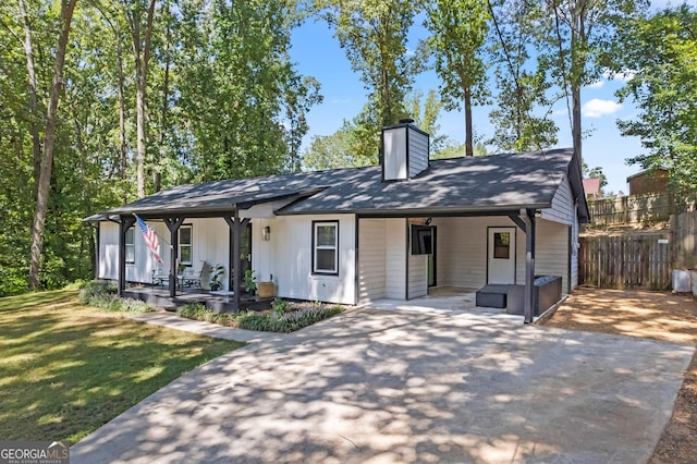 single story home with a porch and a front yard