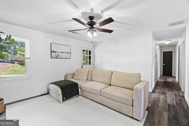 living room featuring ceiling fan and hardwood / wood-style flooring