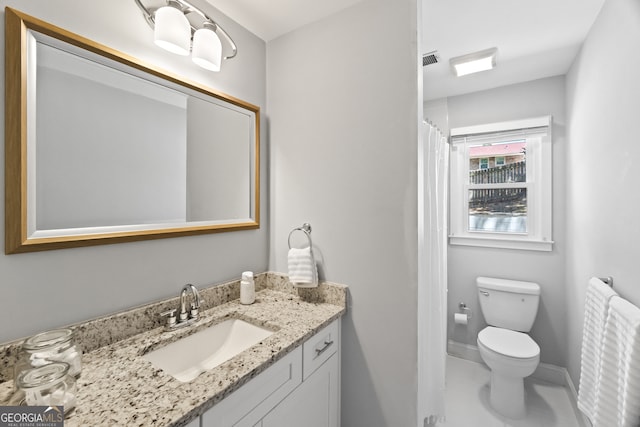 bathroom featuring vanity and toilet