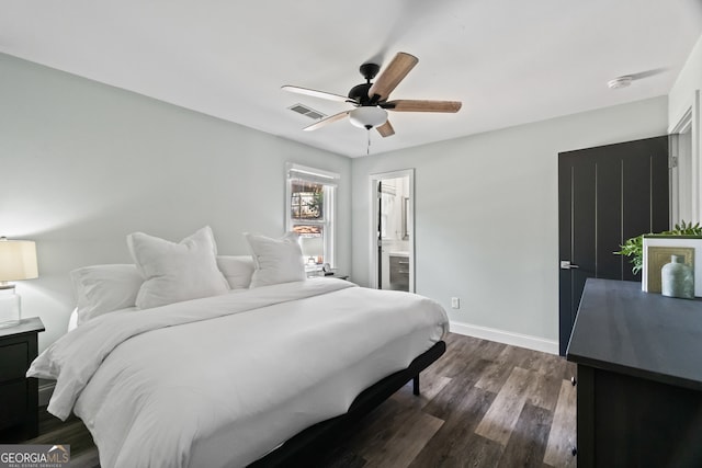 bedroom featuring ceiling fan, dark hardwood / wood-style floors, and ensuite bath