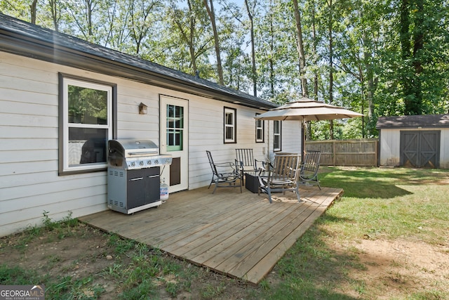 wooden deck featuring grilling area, a shed, and a yard