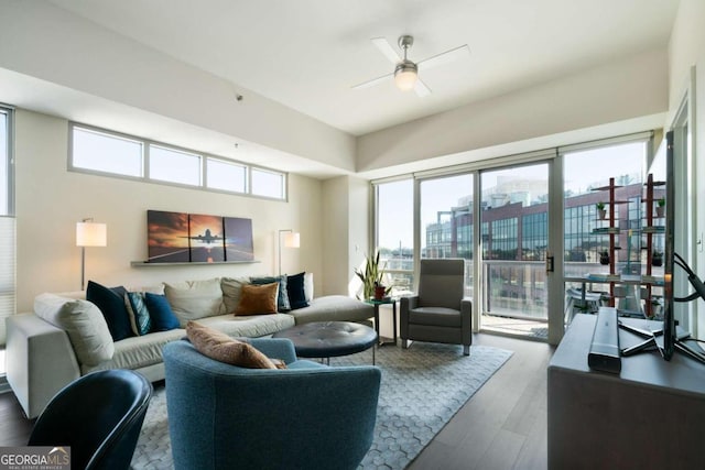 living room with wood-type flooring and ceiling fan