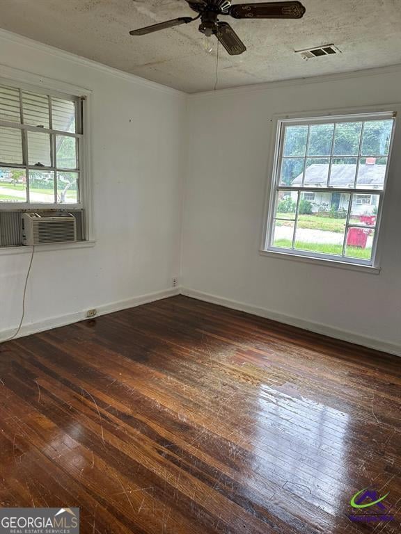 spare room featuring ceiling fan, hardwood / wood-style floors, cooling unit, and ornamental molding