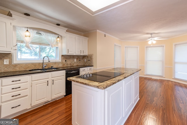 kitchen with sink, dark wood-type flooring, white cabinetry, black appliances, and a center island