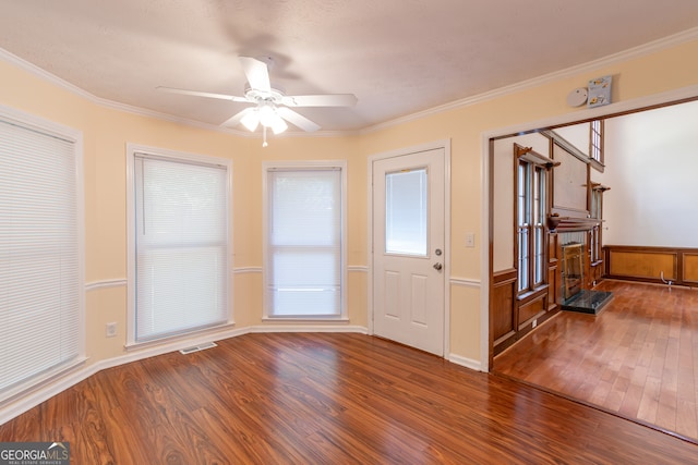 entrance foyer with ceiling fan, hardwood / wood-style flooring, and ornamental molding