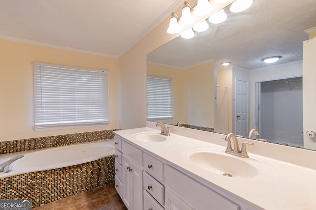 bathroom featuring tiled tub, vanity, crown molding, and tile patterned floors