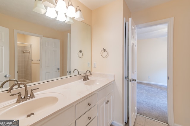 bathroom featuring tile patterned flooring, vanity, and tiled shower