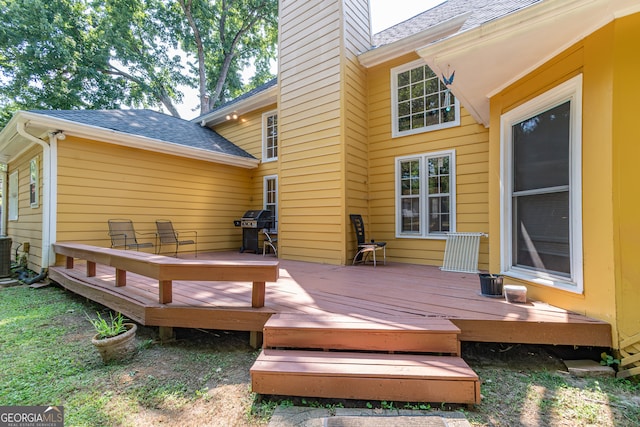 deck featuring central AC unit and grilling area