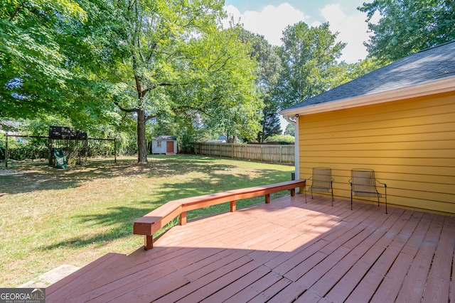 deck featuring a yard and a storage unit