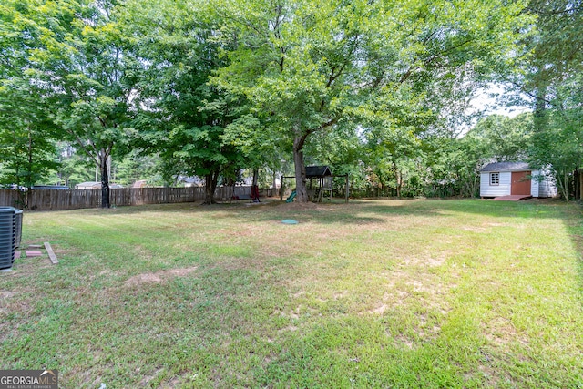 view of yard featuring a playground and a storage shed