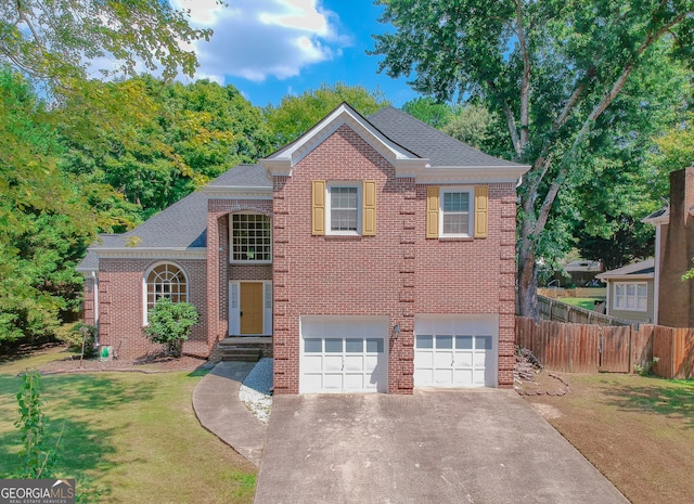 view of front of home with a front yard and a garage