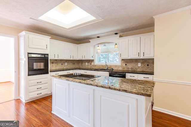 kitchen featuring wood-type flooring, white cabinets, sink, and black appliances