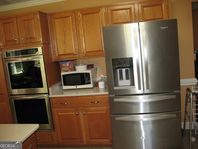 kitchen featuring crown molding and stainless steel appliances