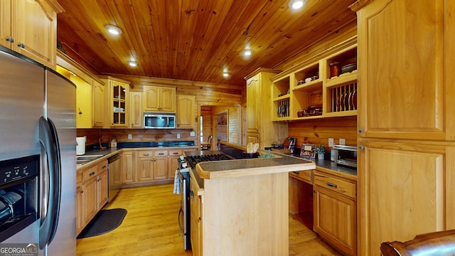 kitchen featuring stainless steel appliances, light hardwood / wood-style flooring, wooden walls, and wood ceiling