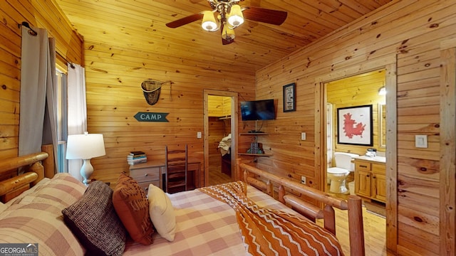 bedroom featuring wood walls, wood-type flooring, wood ceiling, ceiling fan, and ensuite bathroom