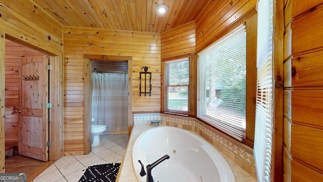 bathroom with wood walls, wooden ceiling, tile patterned flooring, a bathtub, and toilet