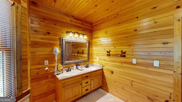 bathroom with tile patterned floors, double sink vanity, wooden walls, and wood ceiling