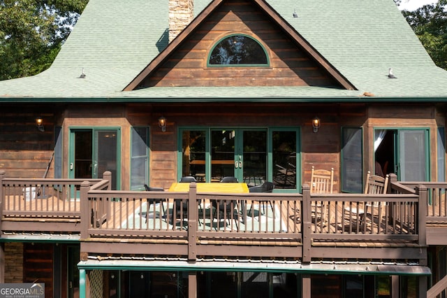 rear view of house with a wooden deck