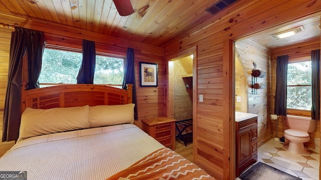 tiled bedroom featuring wood walls, ceiling fan, and wooden ceiling