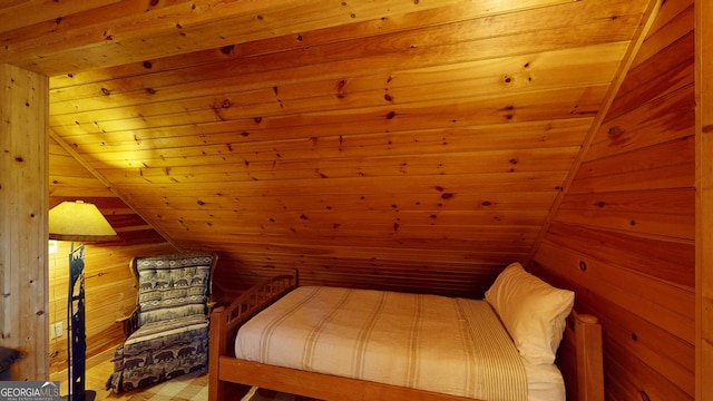 bedroom with wood walls, lofted ceiling, and wooden ceiling