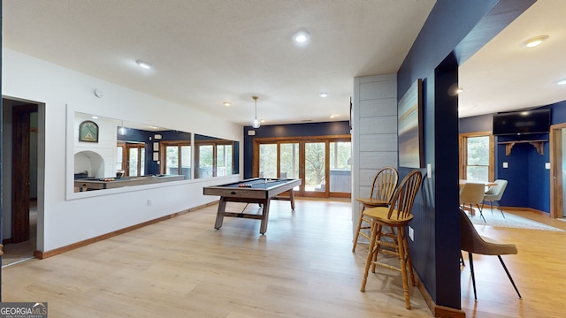 game room with plenty of natural light, pool table, and light hardwood / wood-style flooring