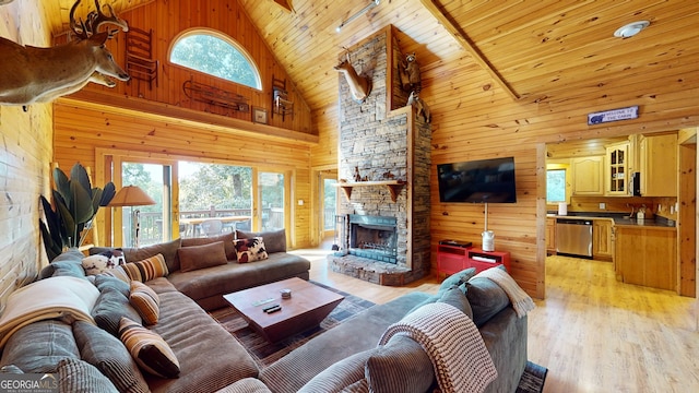 living room with a fireplace, wood walls, light hardwood / wood-style floors, and wood ceiling