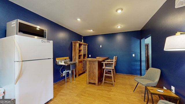 interior space featuring light wood-type flooring and white fridge