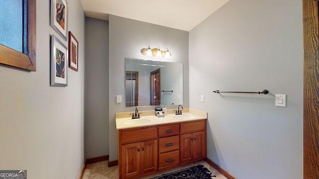 bathroom featuring tile patterned flooring and dual vanity