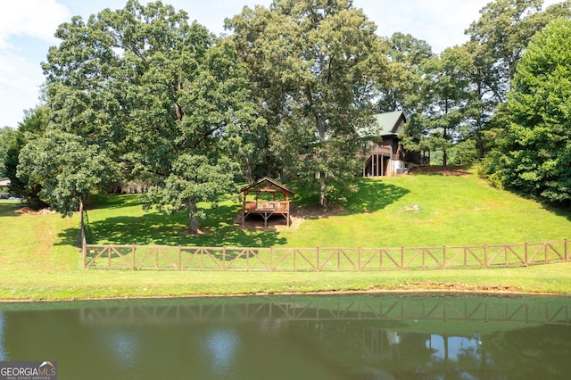 exterior space with a lawn and a water view