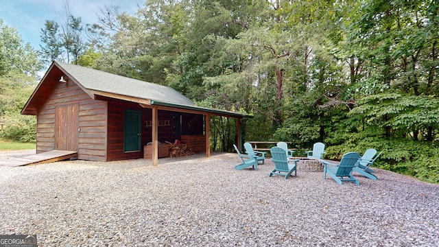 exterior space with an outdoor structure and a fire pit