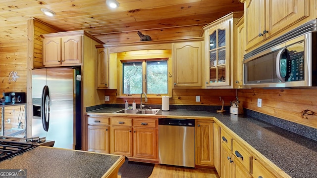 kitchen with light wood-type flooring, appliances with stainless steel finishes, sink, and wood ceiling