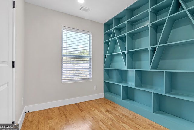 interior space with plenty of natural light and hardwood / wood-style floors