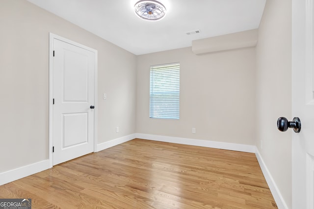 spare room featuring light hardwood / wood-style floors