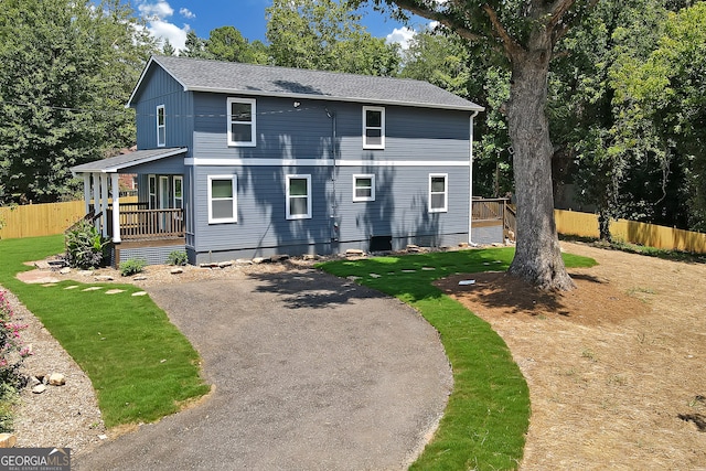 view of property featuring a front lawn and covered porch