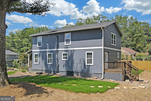 back of property with a wooden deck